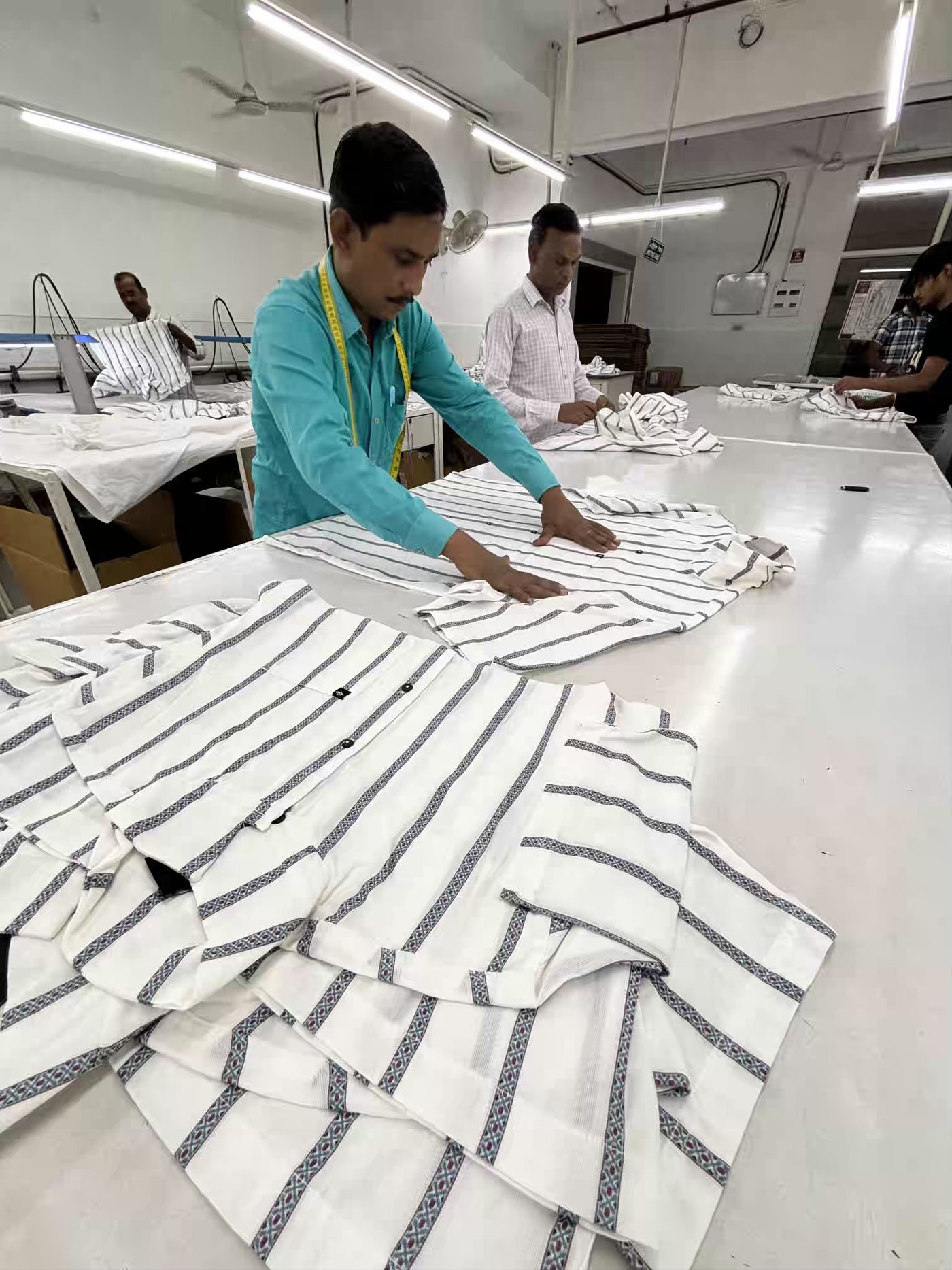 In-line quality check during production at Myra Enterprises garment factory